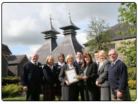 A photo of Strathisla Distillery receiving its  award for a  Five Star visitor center status by Visit Scotland, the country’s official national tourism organisation.