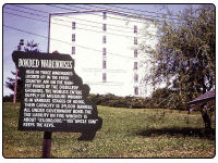 A photo of the McCormick Distillery with a entrance message regarding their warehouses