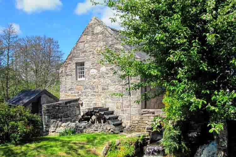 A photo through the trees of The Speyside Distillery in Kingussie, Inverness-shire