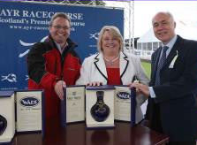 Iain Weir, Marketing Director, Ian Macleod Distillers Ltd. presents a rare bottle of Isle of Skye 21 Year Old to competition winner Marilyn Dalgleish and her husband.